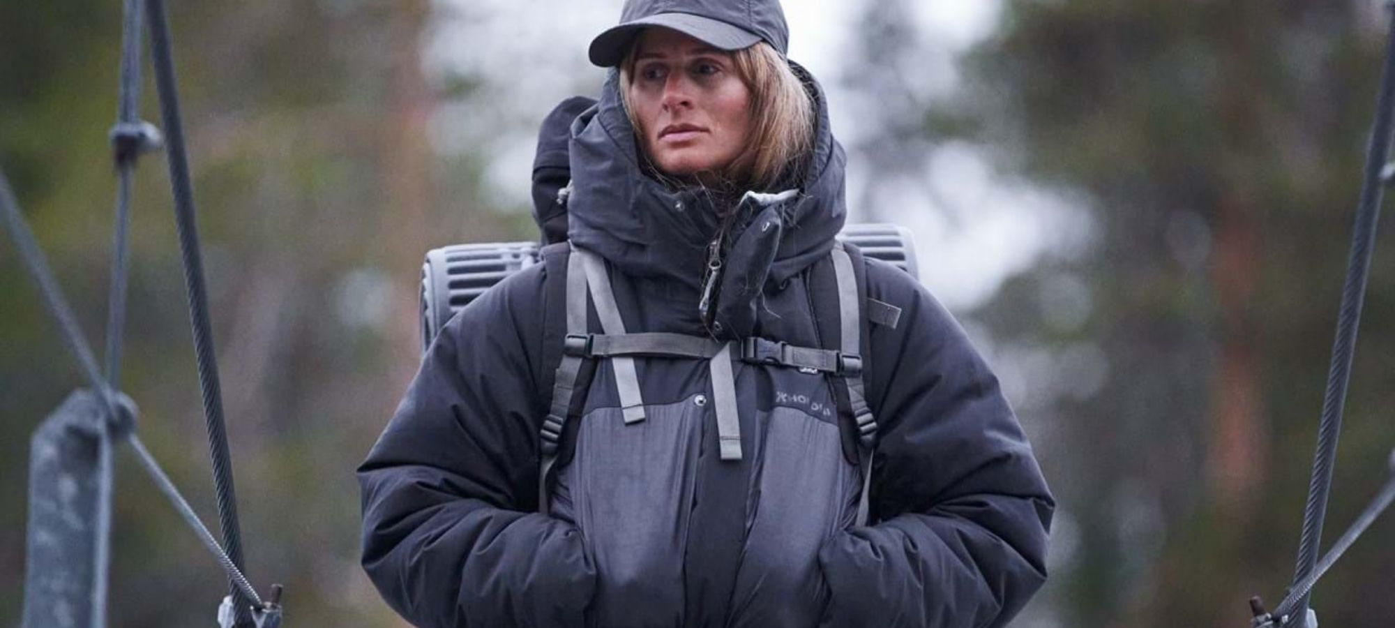 Person outdoors wearing black sustainable insulated jacket made by Houdini.