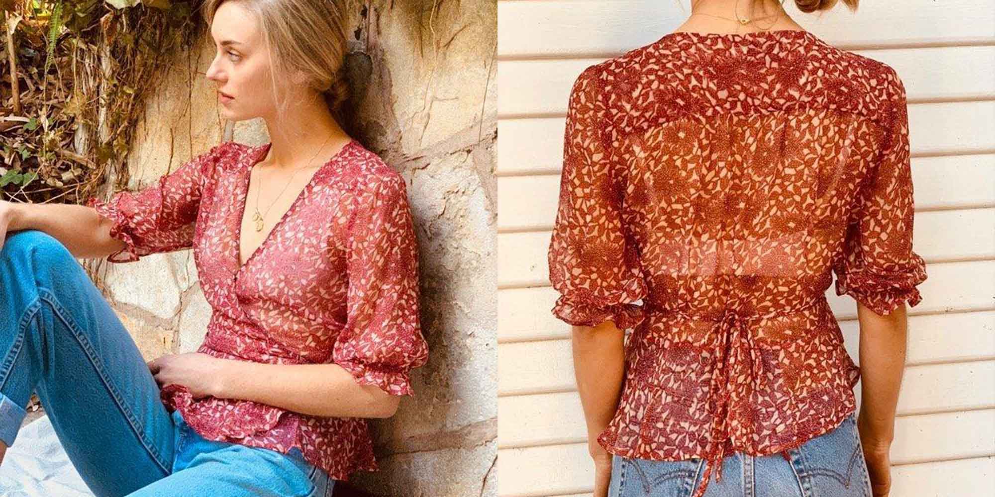 Woman wearing red floral silk shirts by all the wild roses.