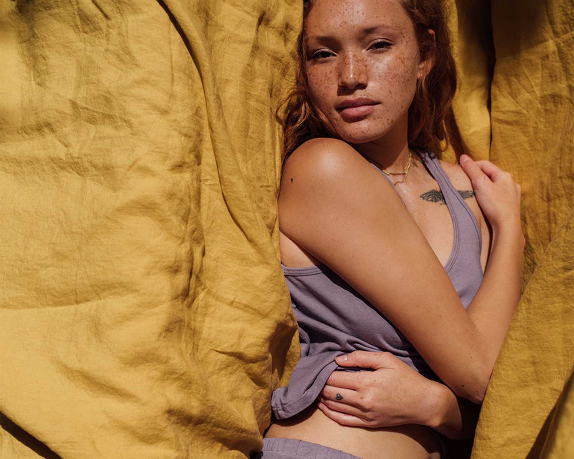 Someone wearing a lavender set of TENCEL Lyocell loungewear singlet and shorts by MATE the Label.