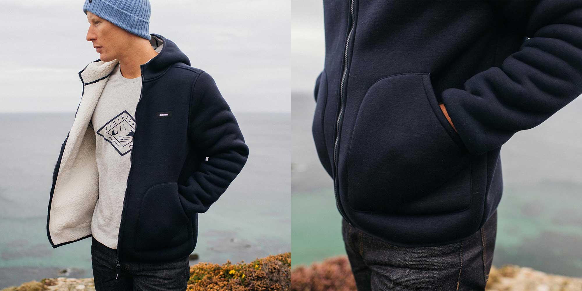 Person standing in front of the sea, wearing a navy outdoor hoodie by Finisterre.