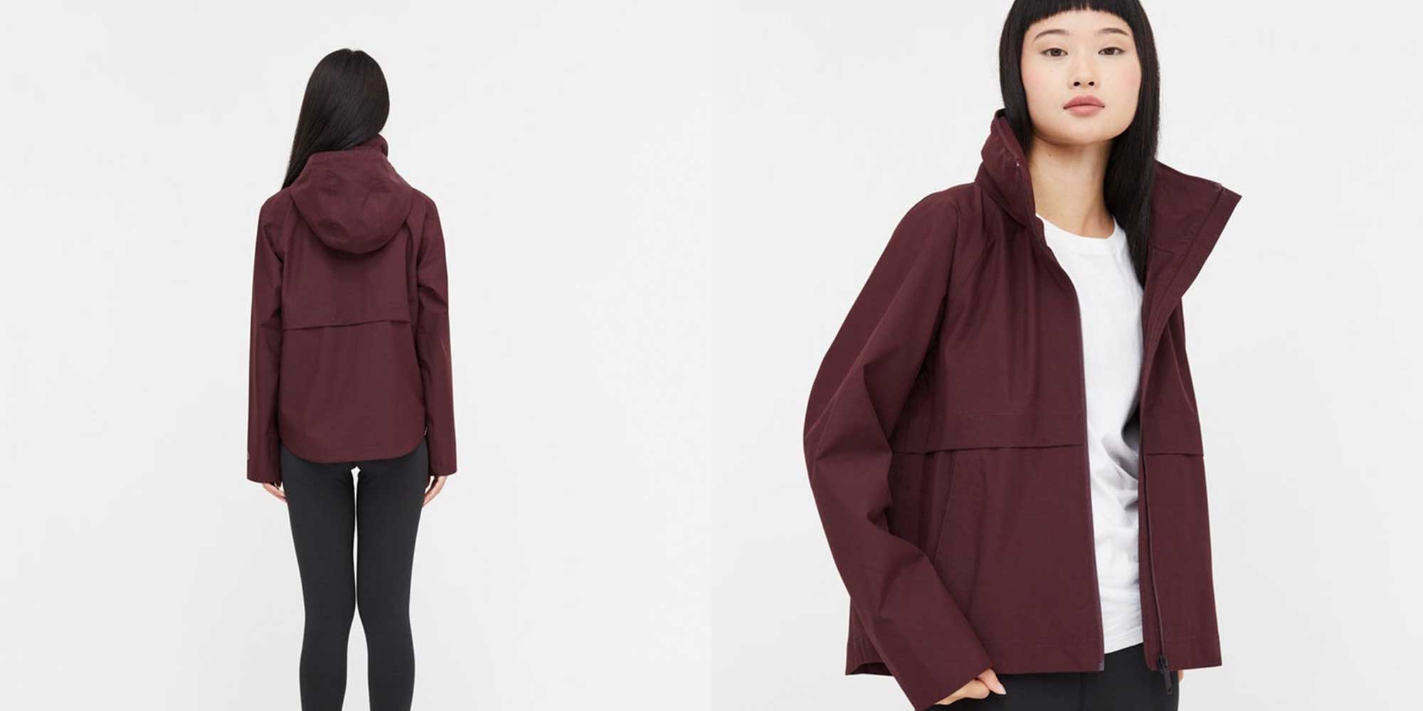 Close-up of a person wearing a burgundy sustainable rain jacket by tentree.