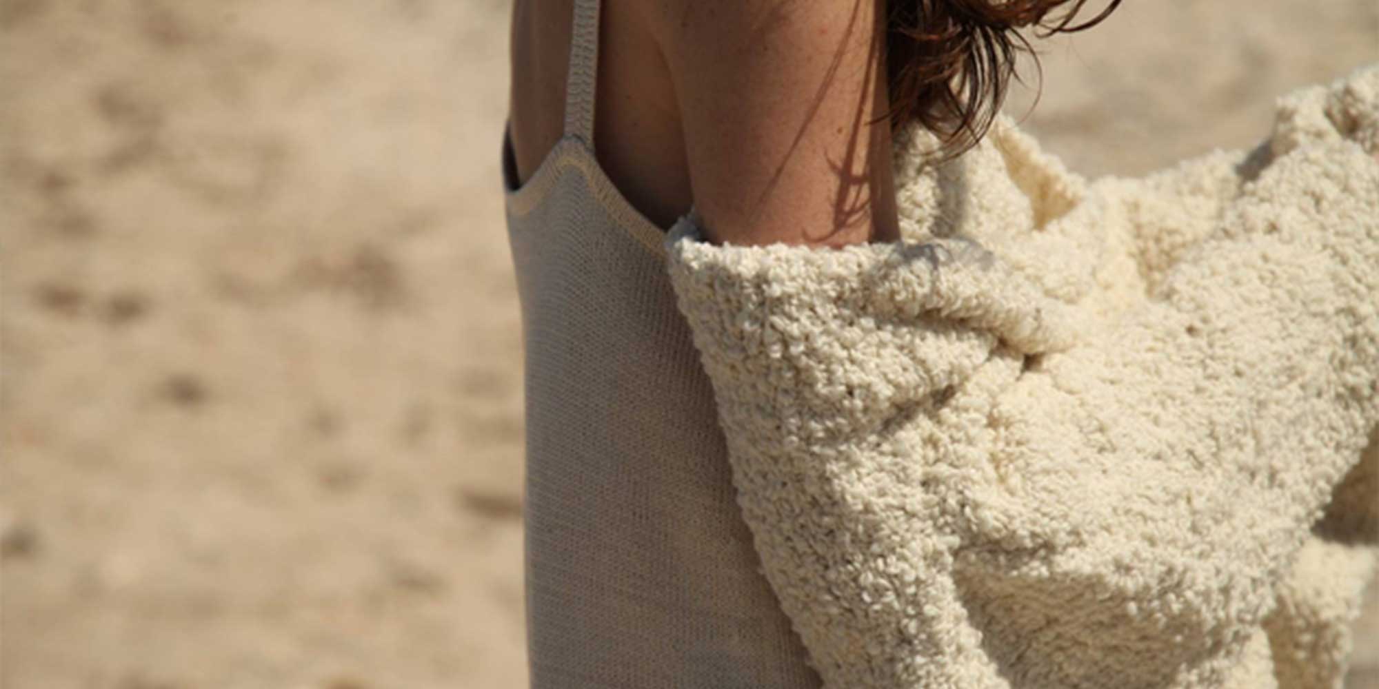 Cropped shot of a fluffy sustainable beige coat by Kordal Studio.