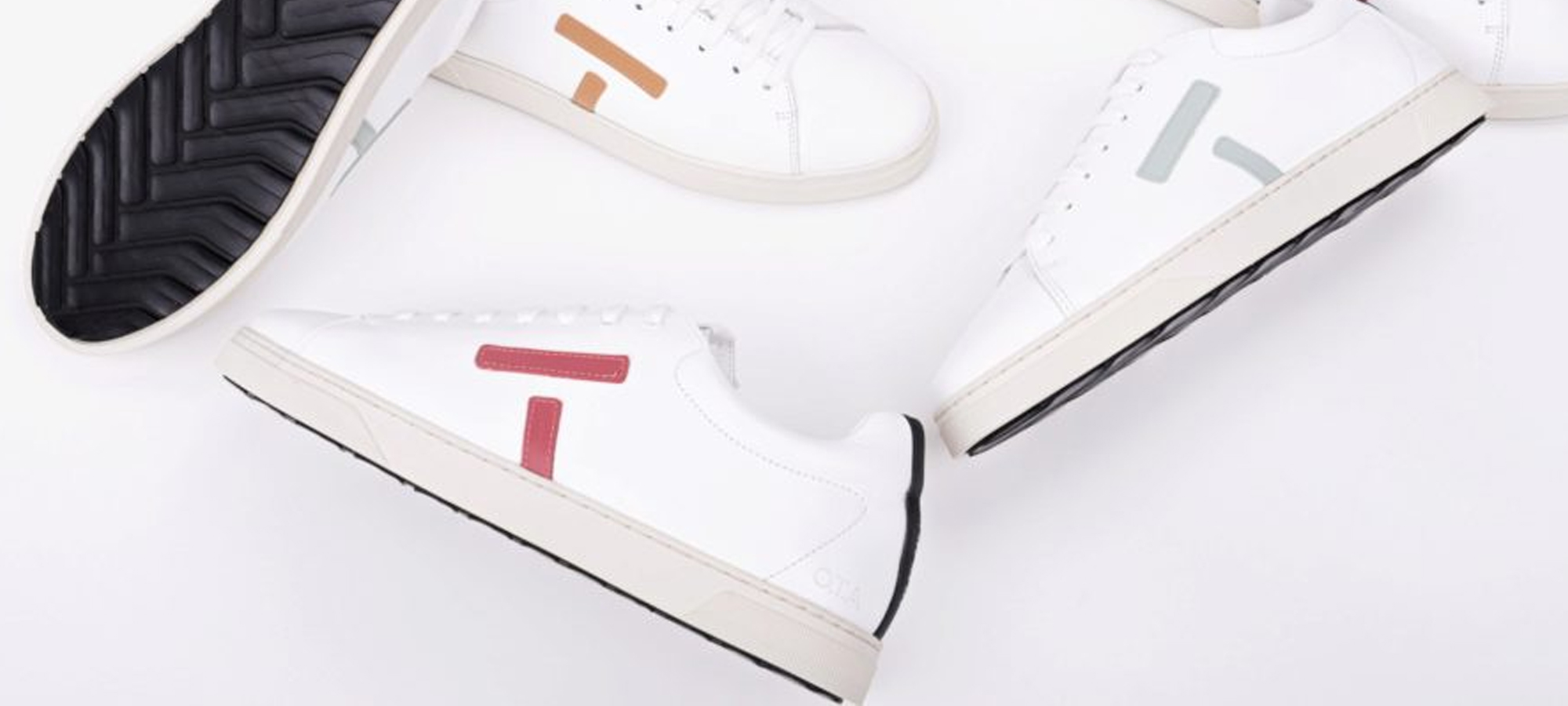 A selection of white sustainable sneakers by OTA.