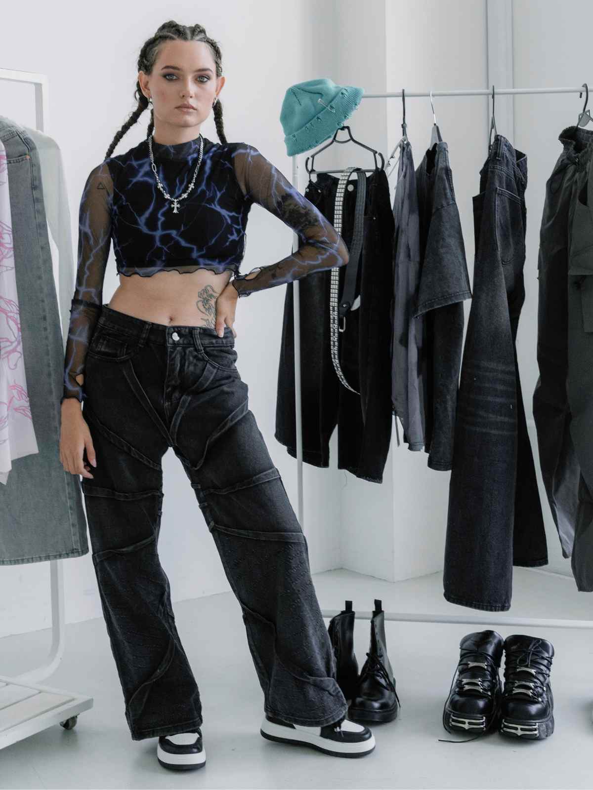 person standing with rails of goth clothing (1)