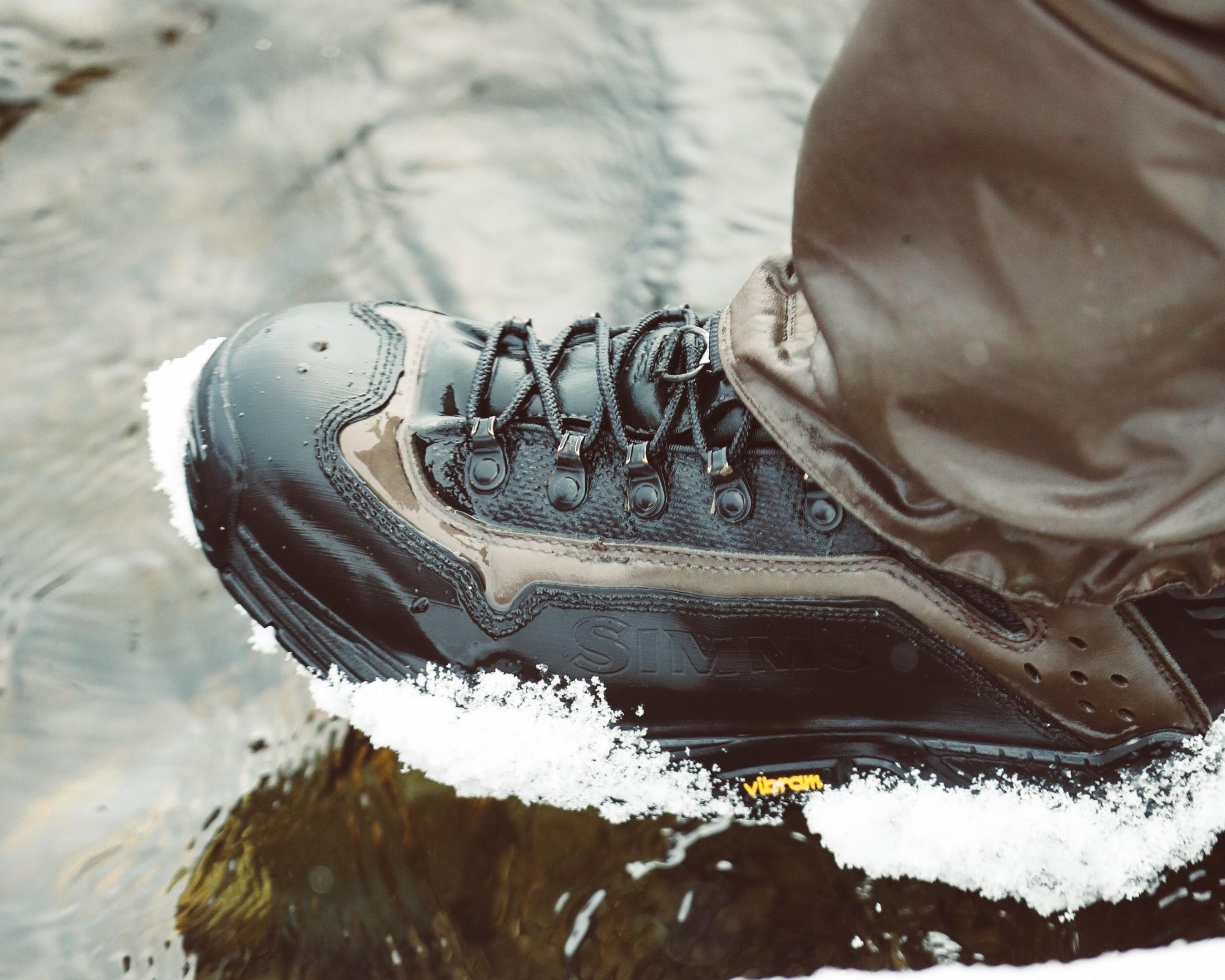 A black Vibram sneaker with frost along the bottom.