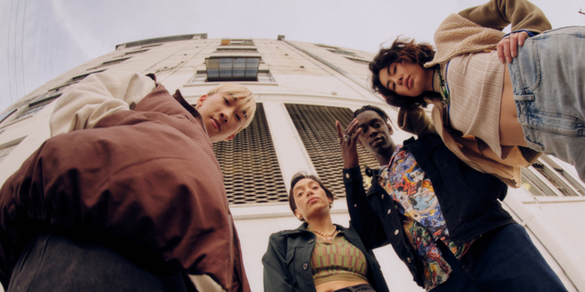 image looking up at four people dressed in Unspun