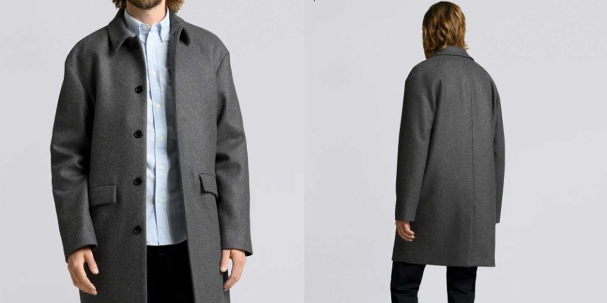 A person wearing a long dark grey coat by Asket.