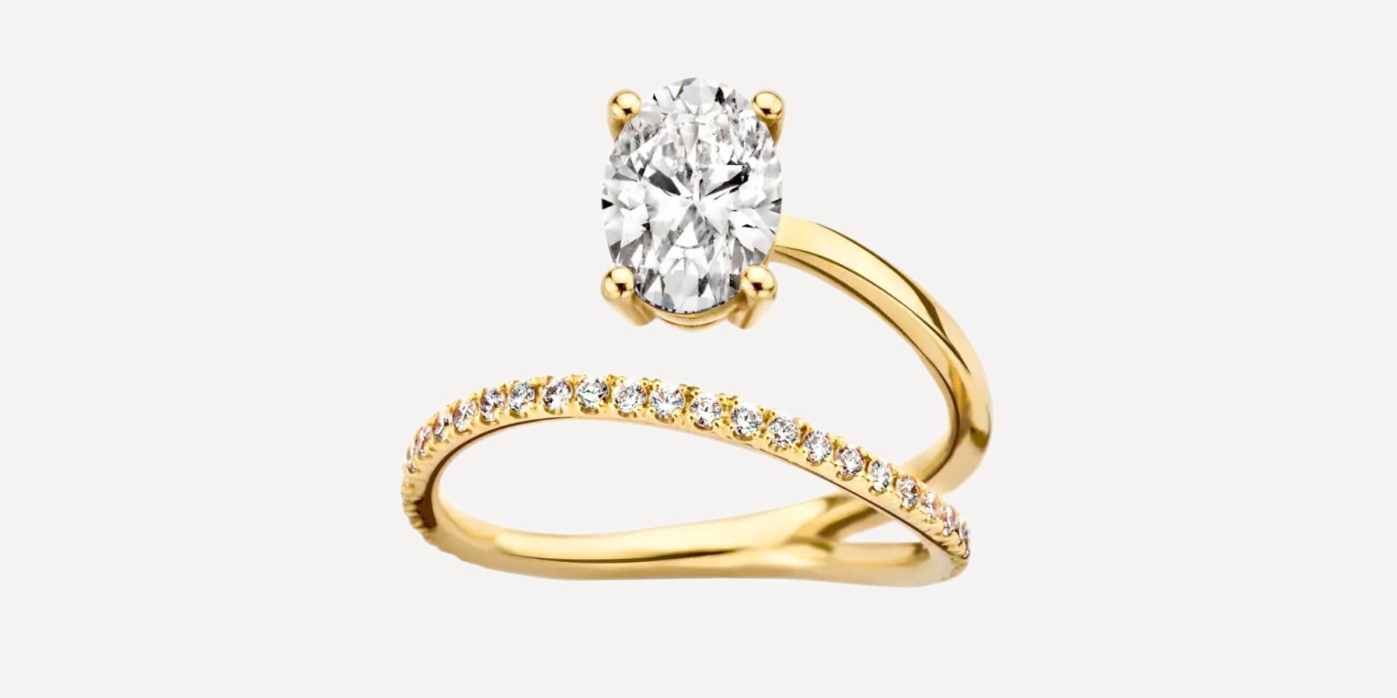 A unique single oval diamond wrap around responsibly-sourced gold engagement ring by Kimai.