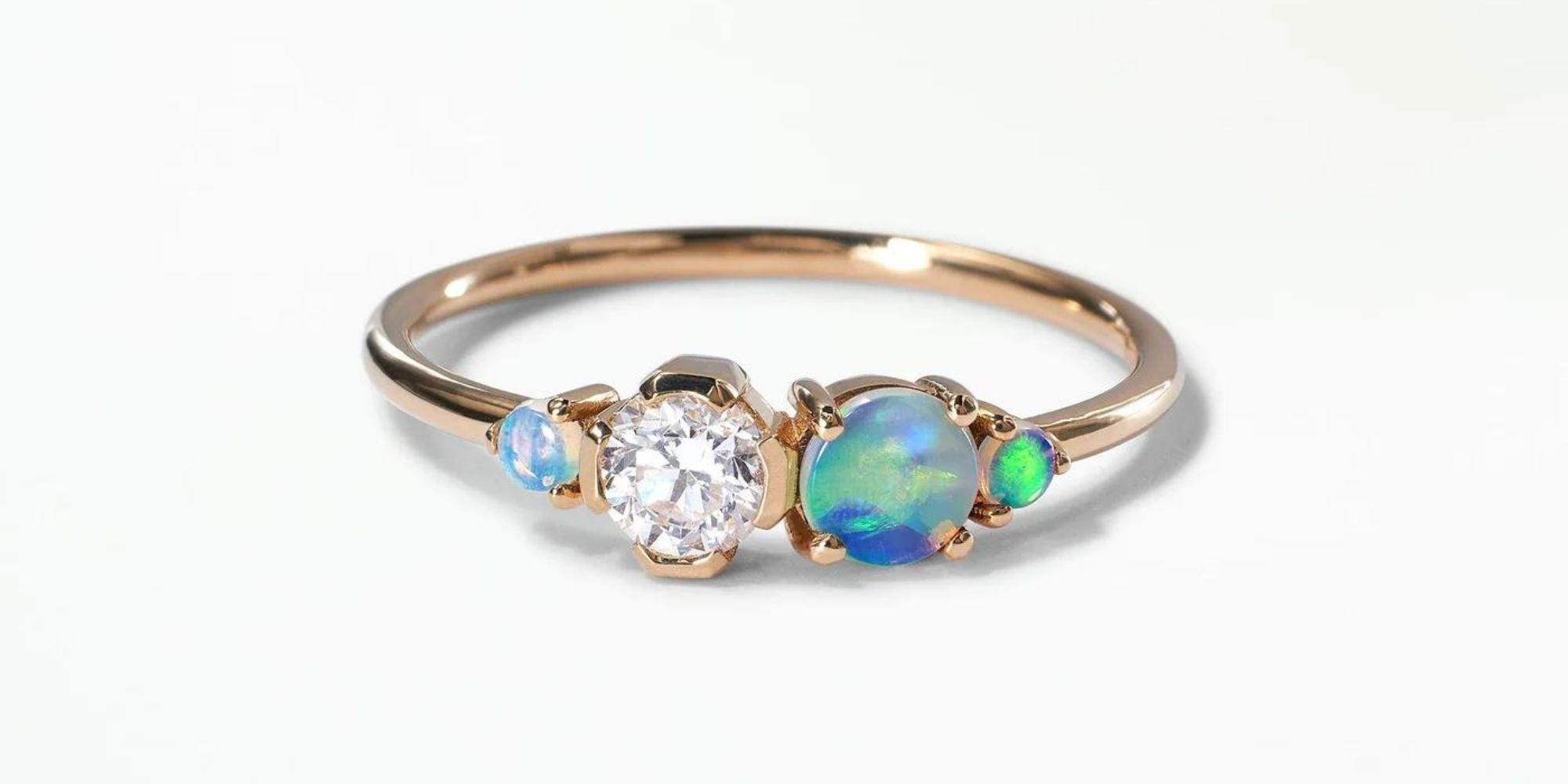 An engagement ring featuring a diamond in a strong octagonal frame surrounded by WWAKE's signature ethereal opals.