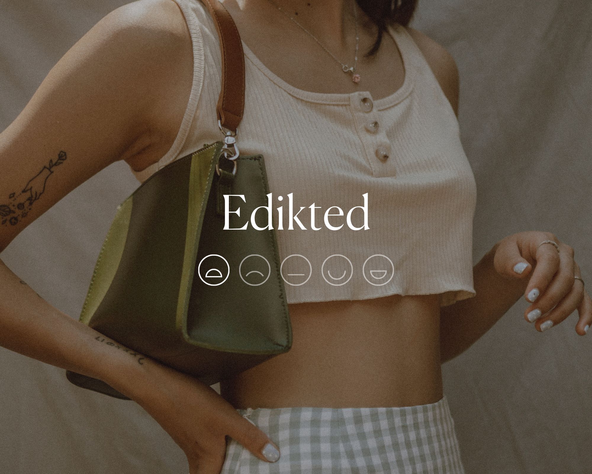Someone wearing a crop top and check skirt with a green bag, overlaid with white text reading Edikted with a highlighted sad face emoji below.