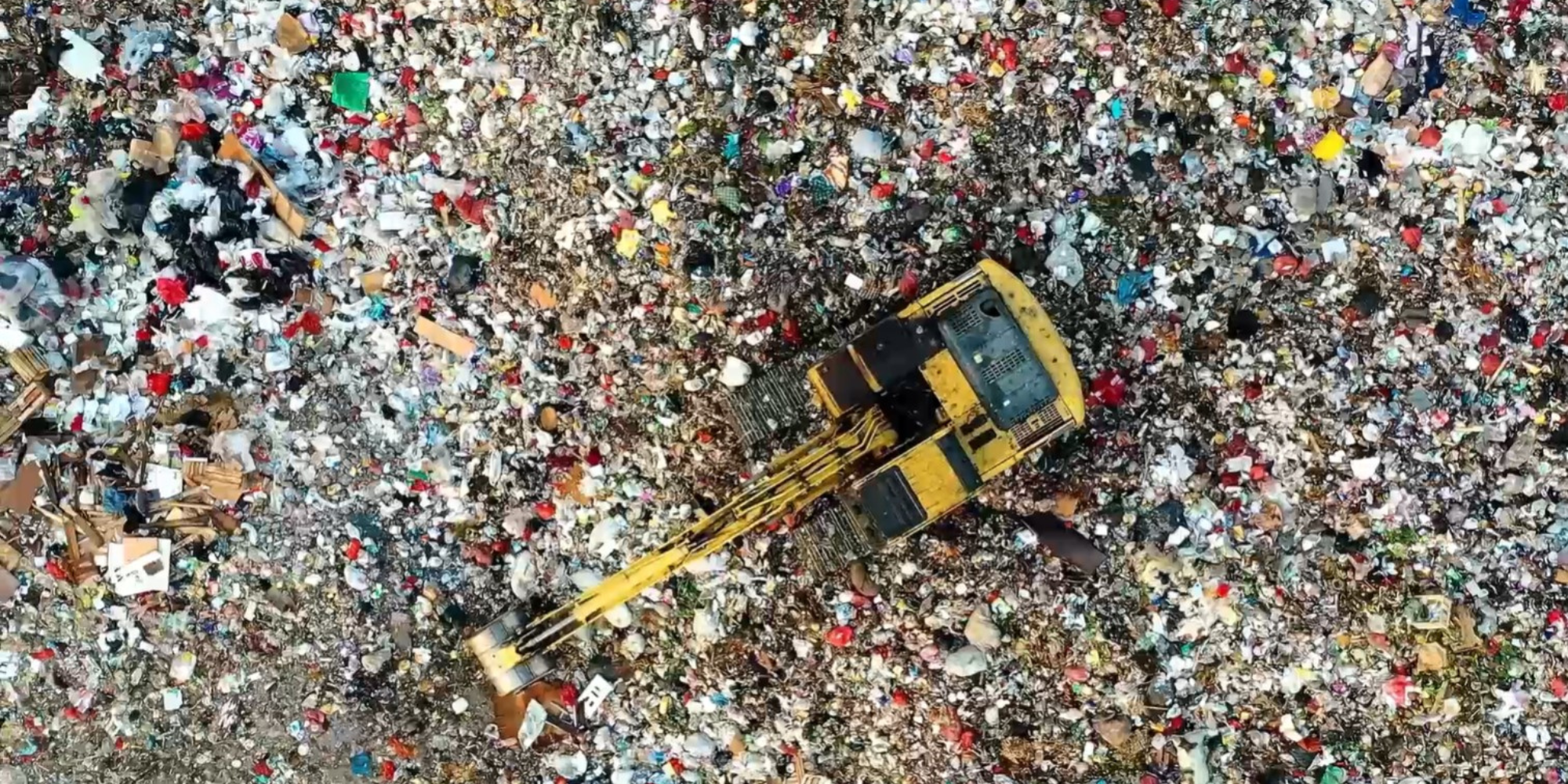 A top-down view of a dump full of waste.