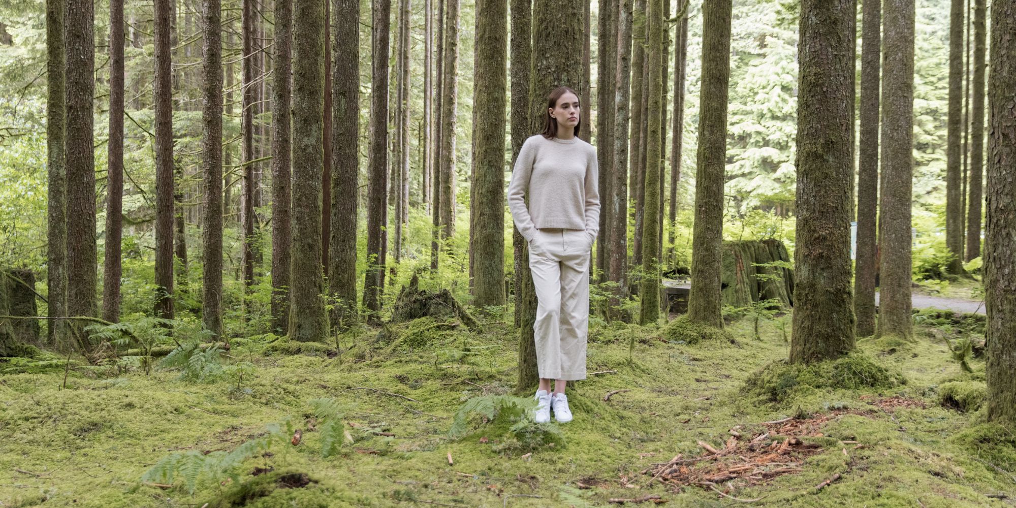 Someone standing alone in the woods wearing Circularity by tentree clothing.