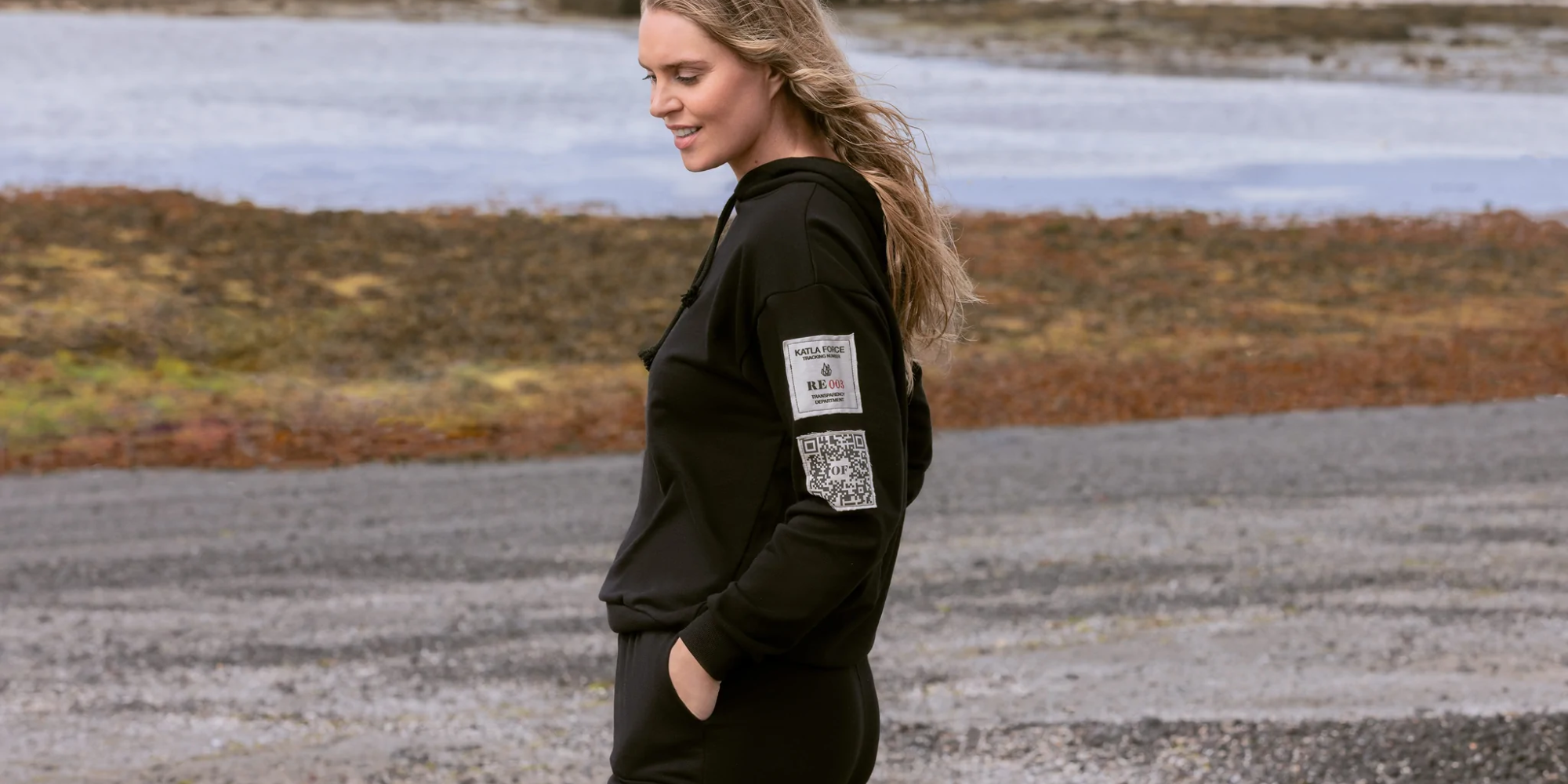 person in hoodie with printed sleeves and sweatpants by Katla