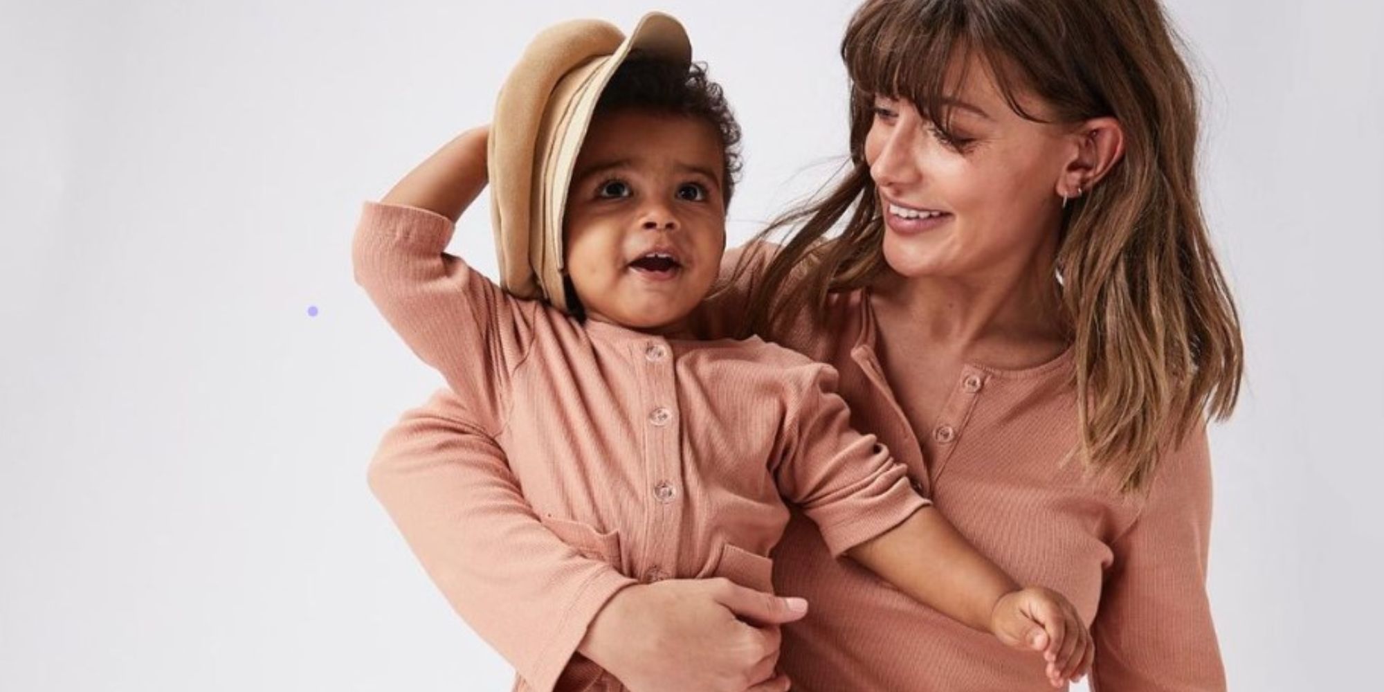 A mother and baby wearing matching pink body sets by Bow&Bo.