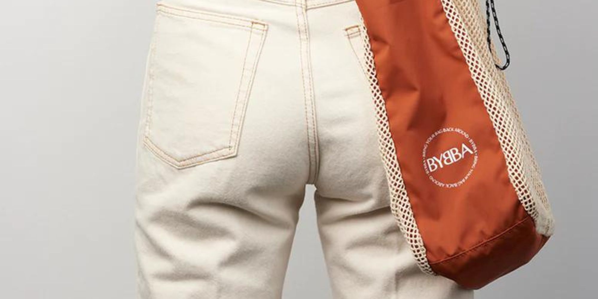 Close up of an orange recycled ocean plastic tote bag by BYBBA.