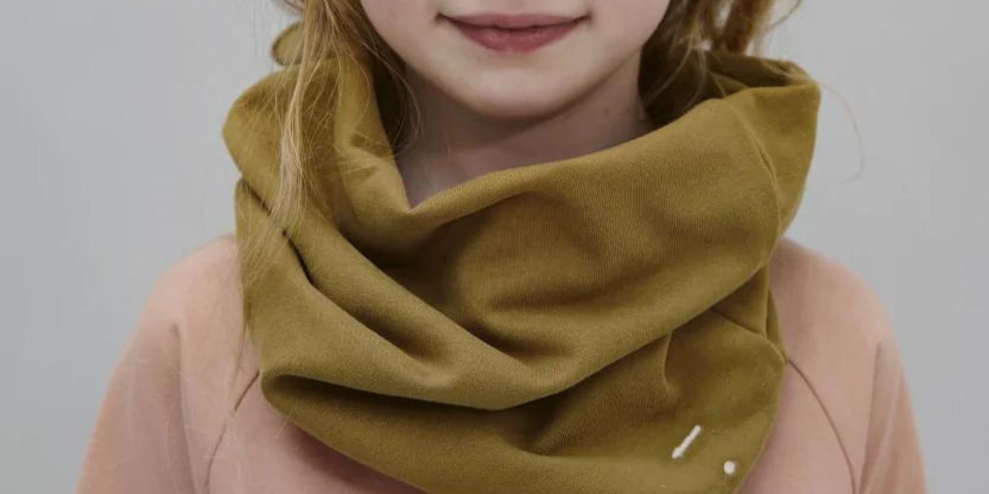 A brown infinity kids' scarf by Gray Label.