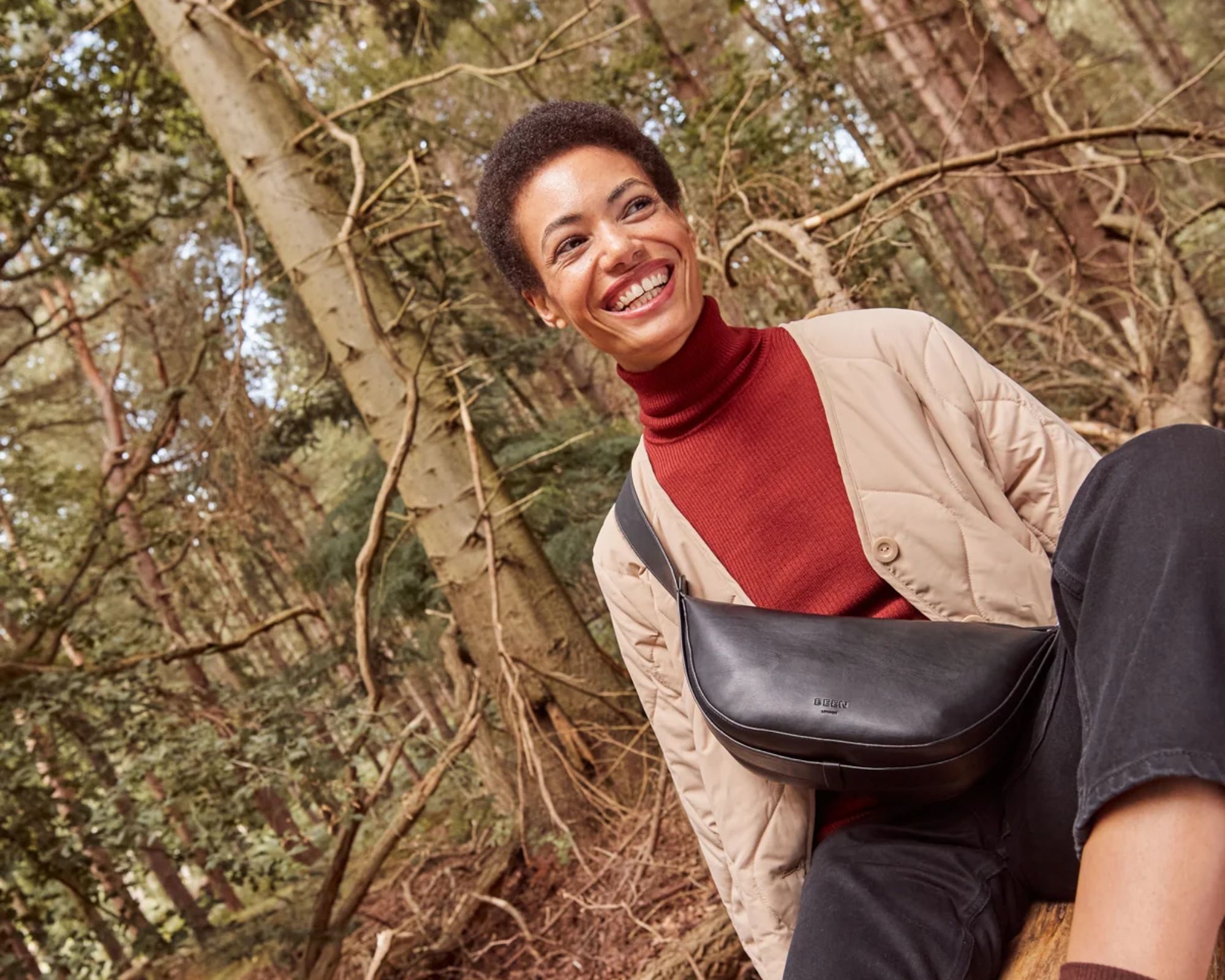 person smiling in the woods