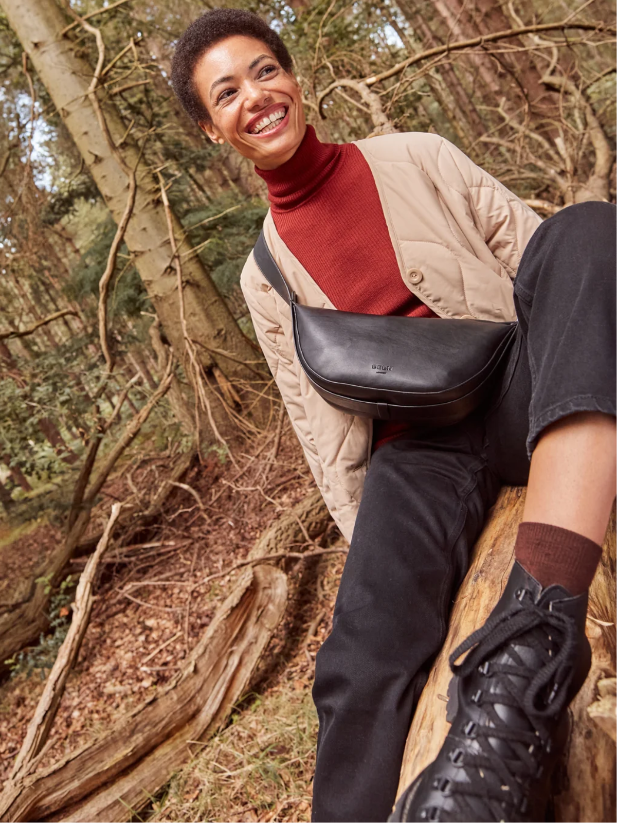 person smiling in the woods