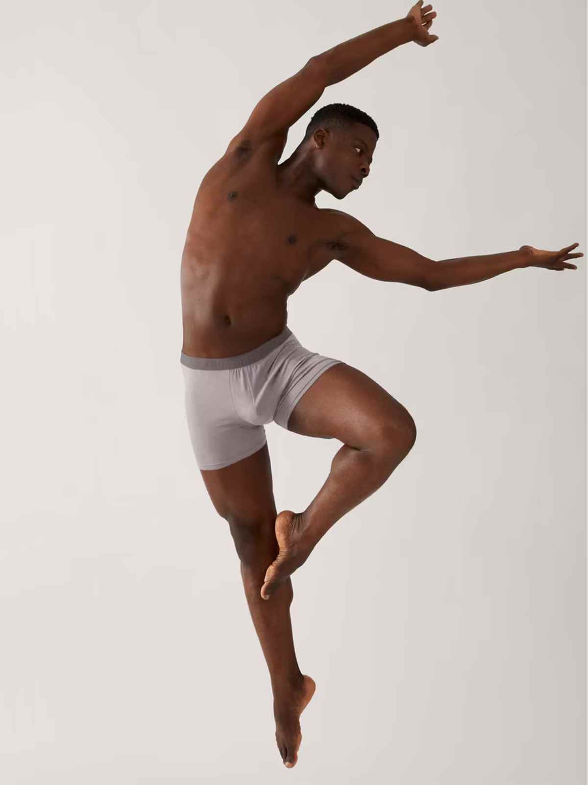 person wearing boxer shorts in ballet pose