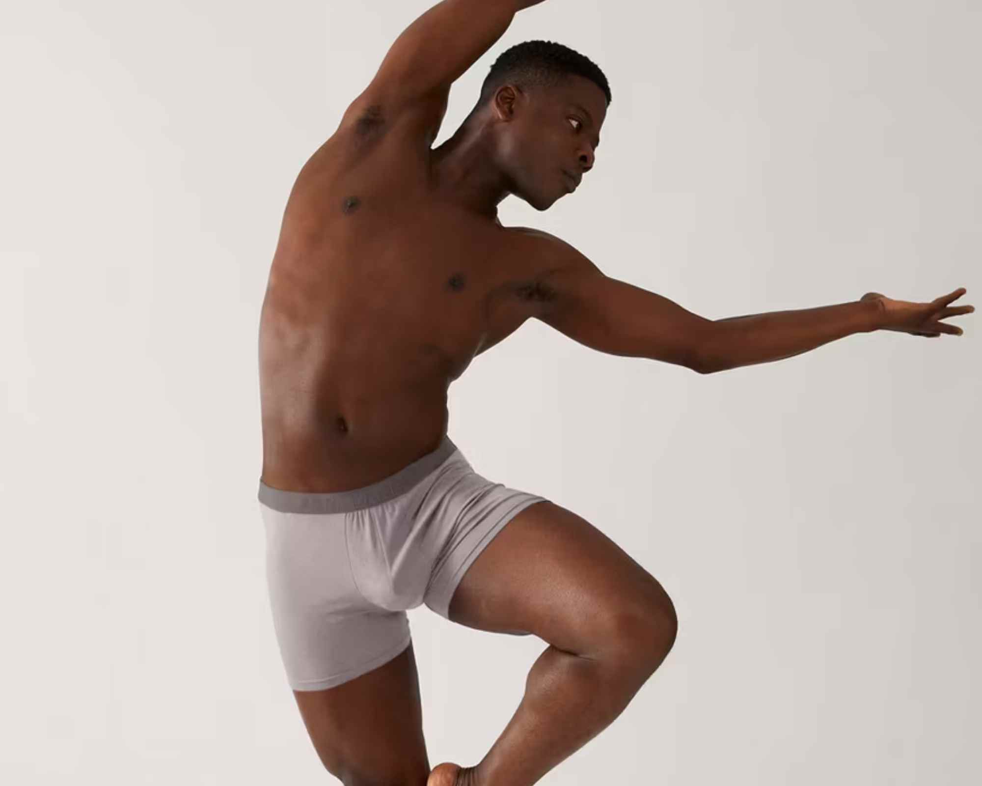 person wearing boxer shorts in ballet pose