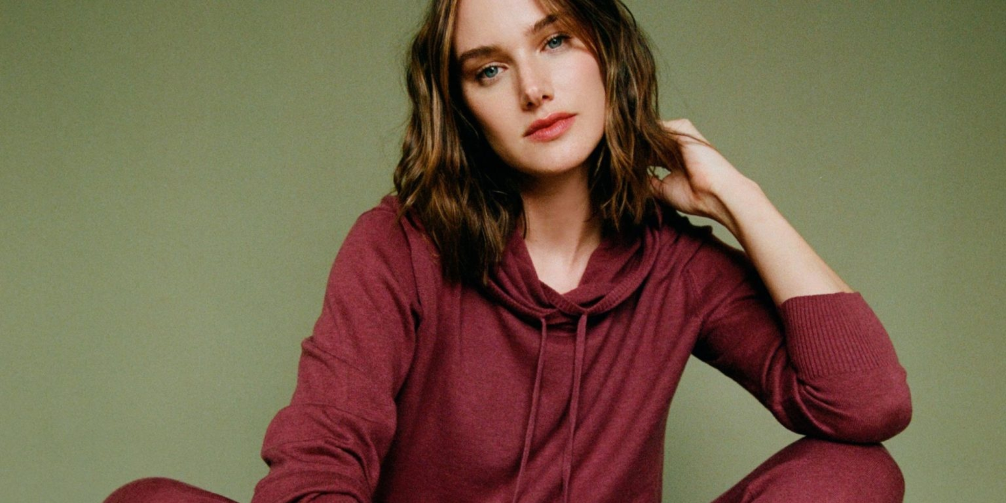 Someone wearing maroon long sleeved top and leggings by Neu Nomads.