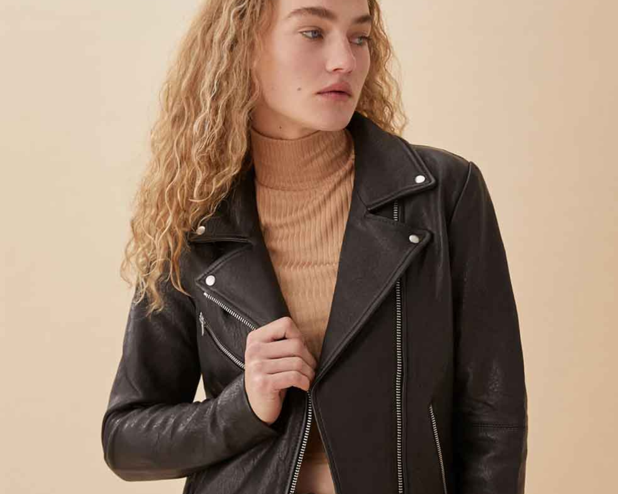 Someone wearing a second hand leather jacket by Reformation.