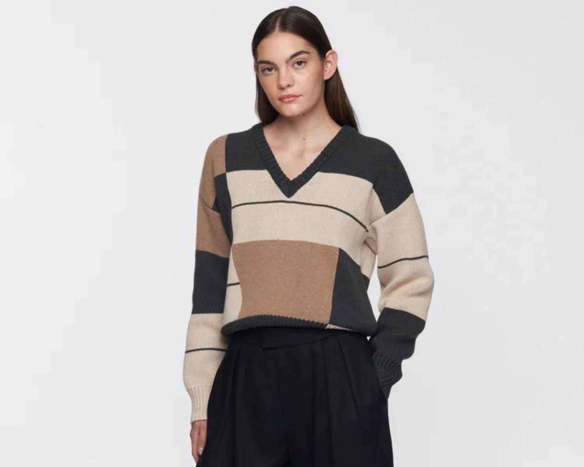 A Christmas lunch outfit featuring Kotn's block printed sweater and black wide leg trousers.