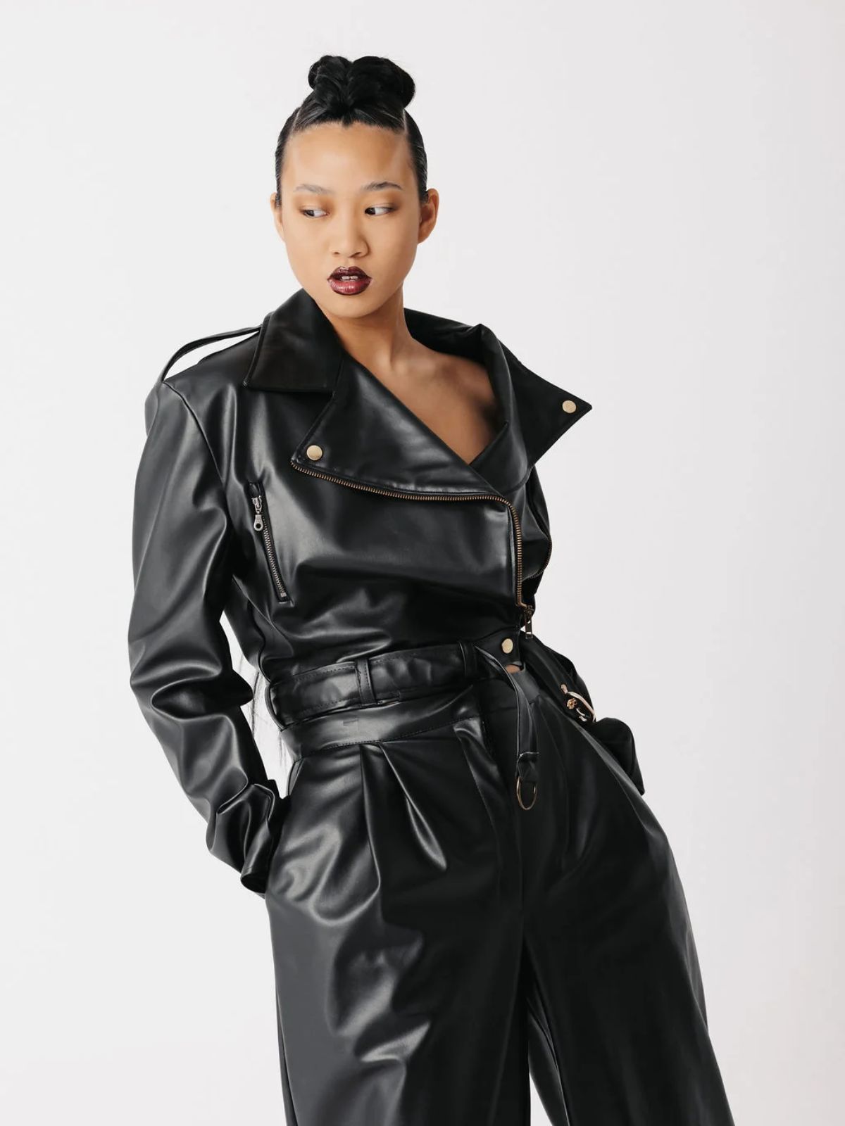 person wearing a black vegan biker jacket from scathed