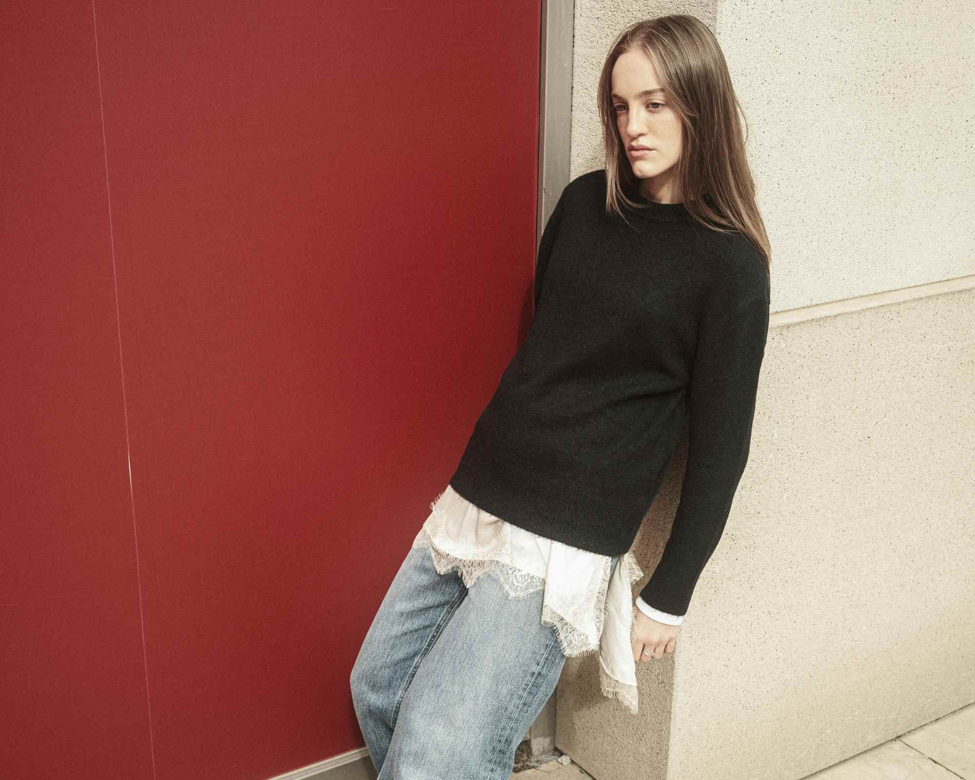 person wearing black sweater and jeans