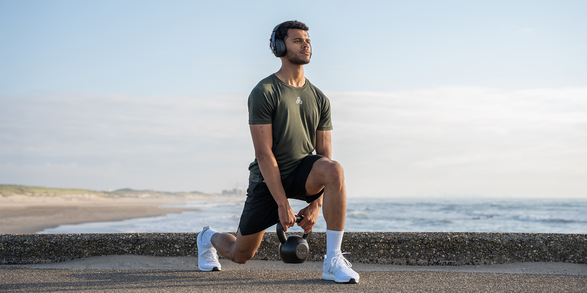 person exercising in shirt and shorts by Iron Roots.