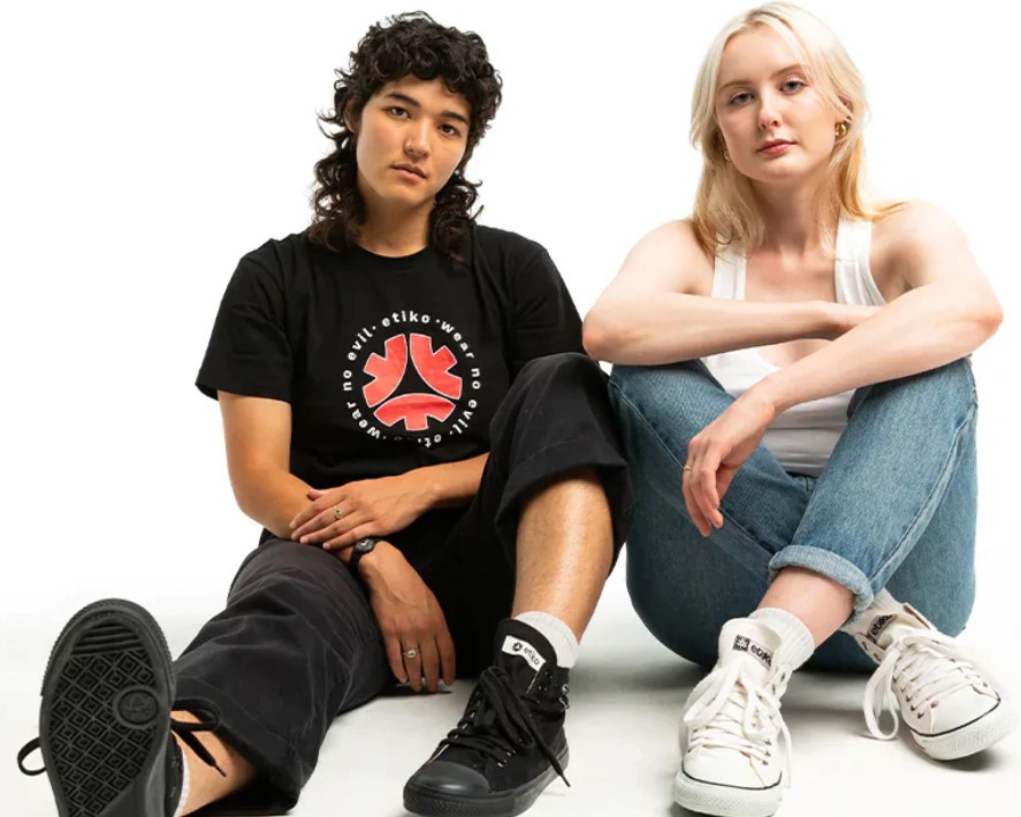 Two people wearing conscious clothing and footwear by Etiko looking at the camera.