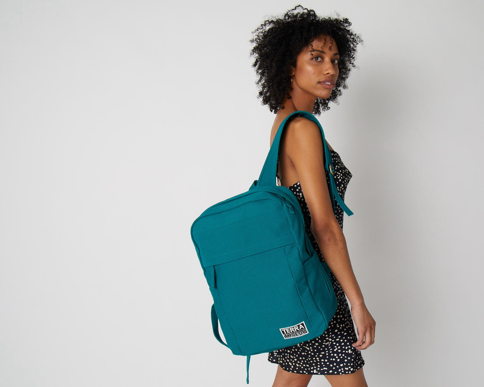 A teal organic cotton backpack made responsibly by Terra Thread.