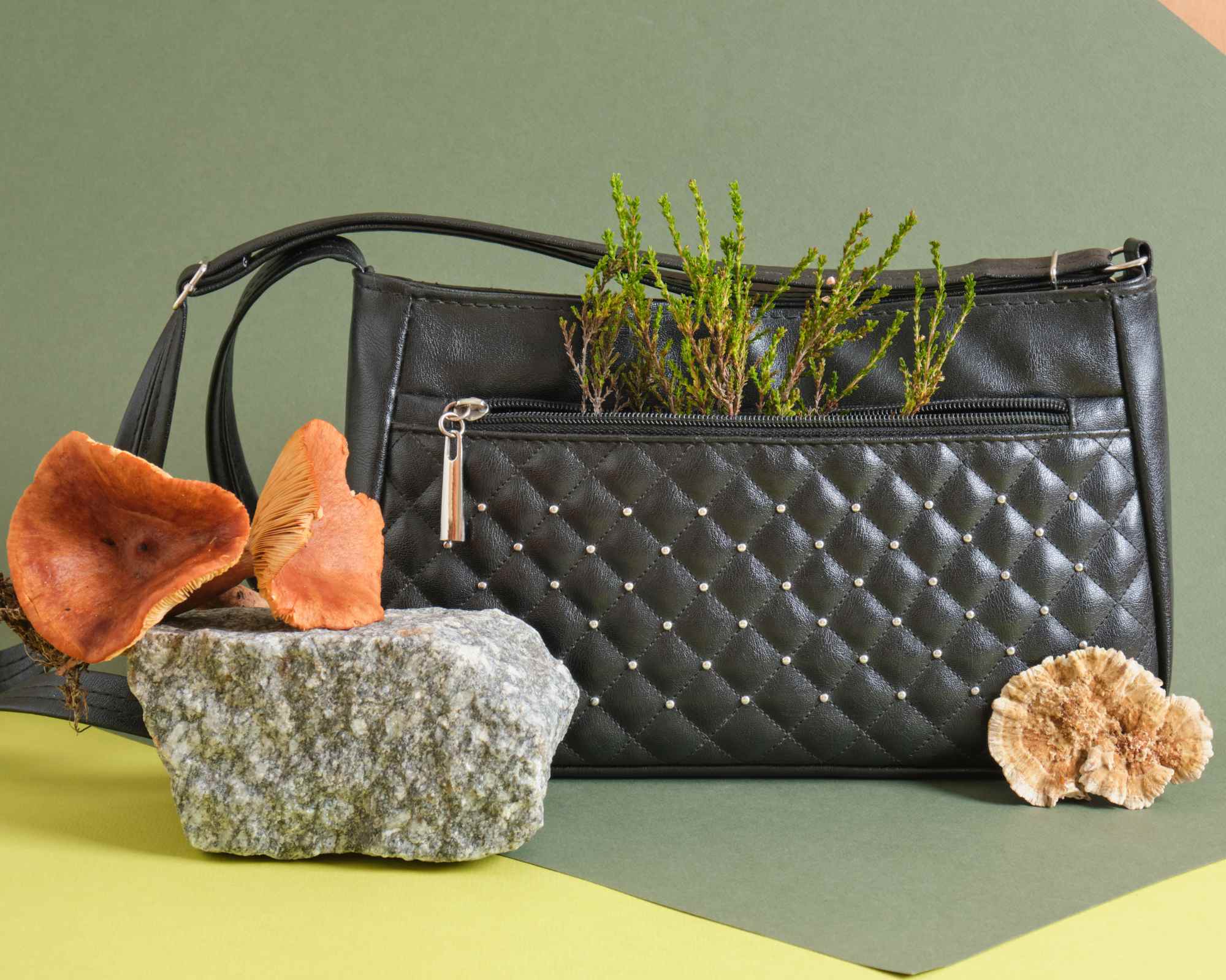 Handbag still life with mushrooms and grass
