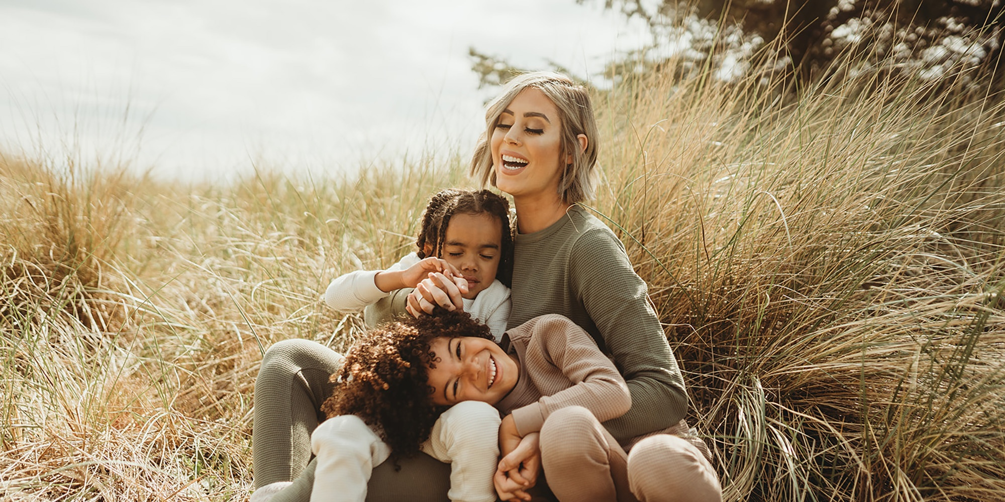 Someone with children dressed in tops and bottoms by Nui Organics.