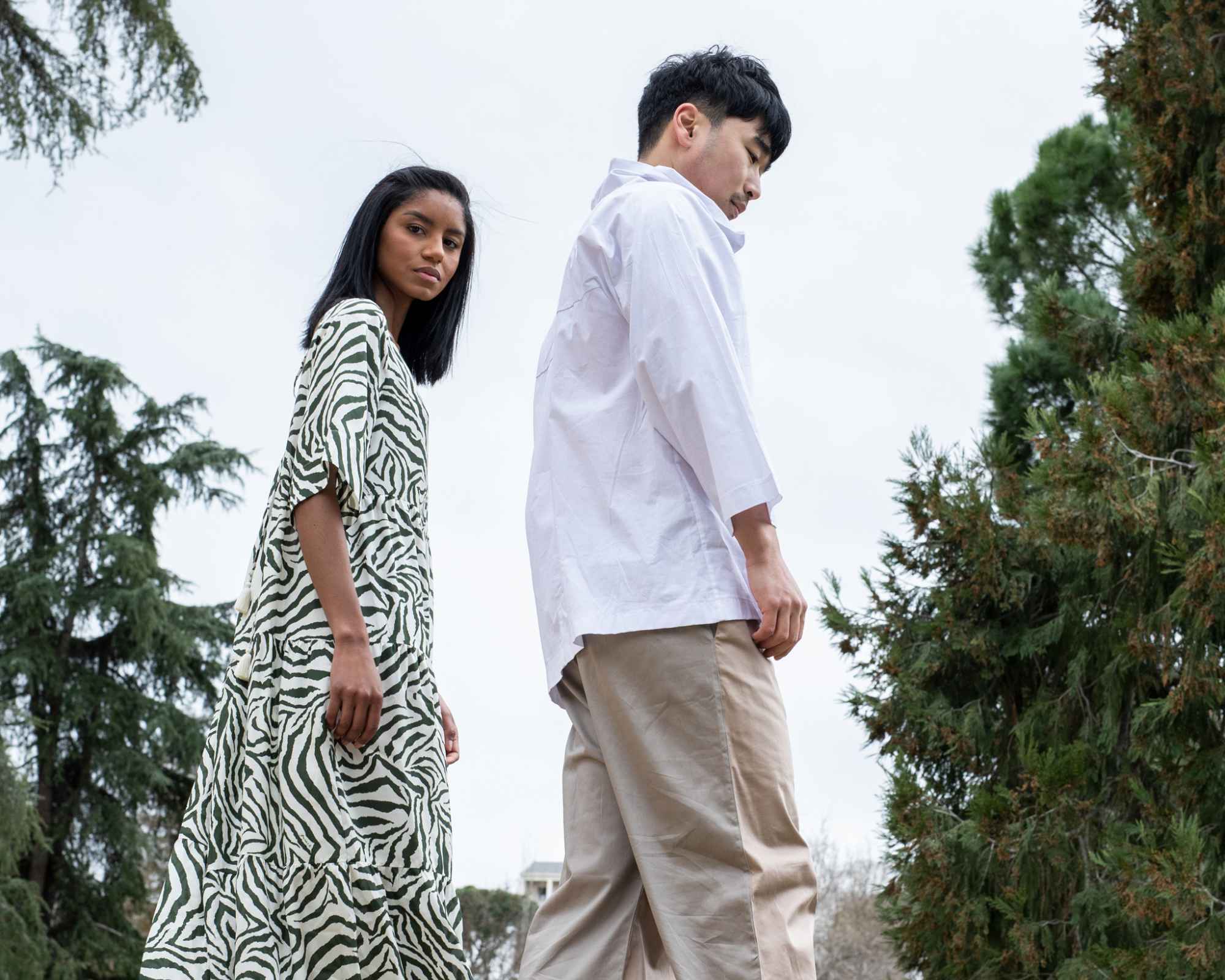 two people walking in the woods
