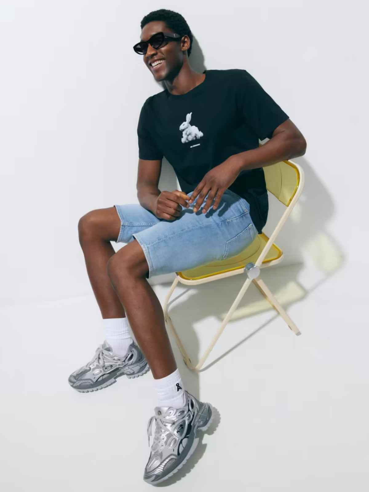 Model wearing sunglasses and casual summer outfit