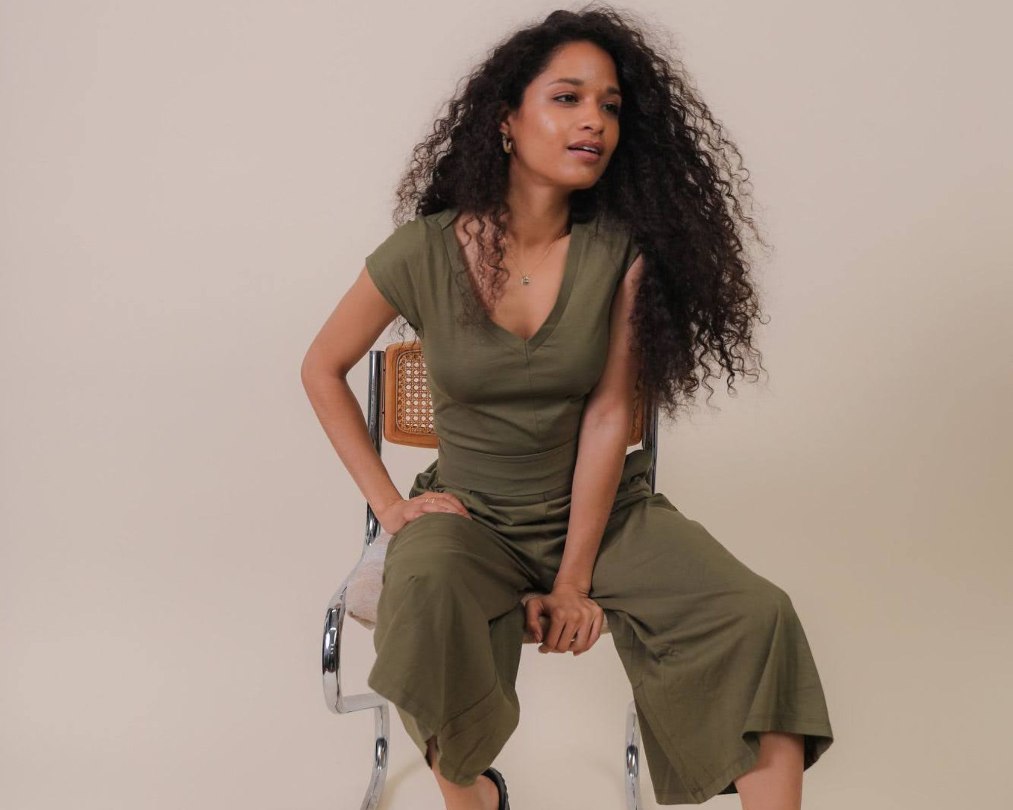 A green responsibly-made jumpsuit for a brand stocked by wearwell.