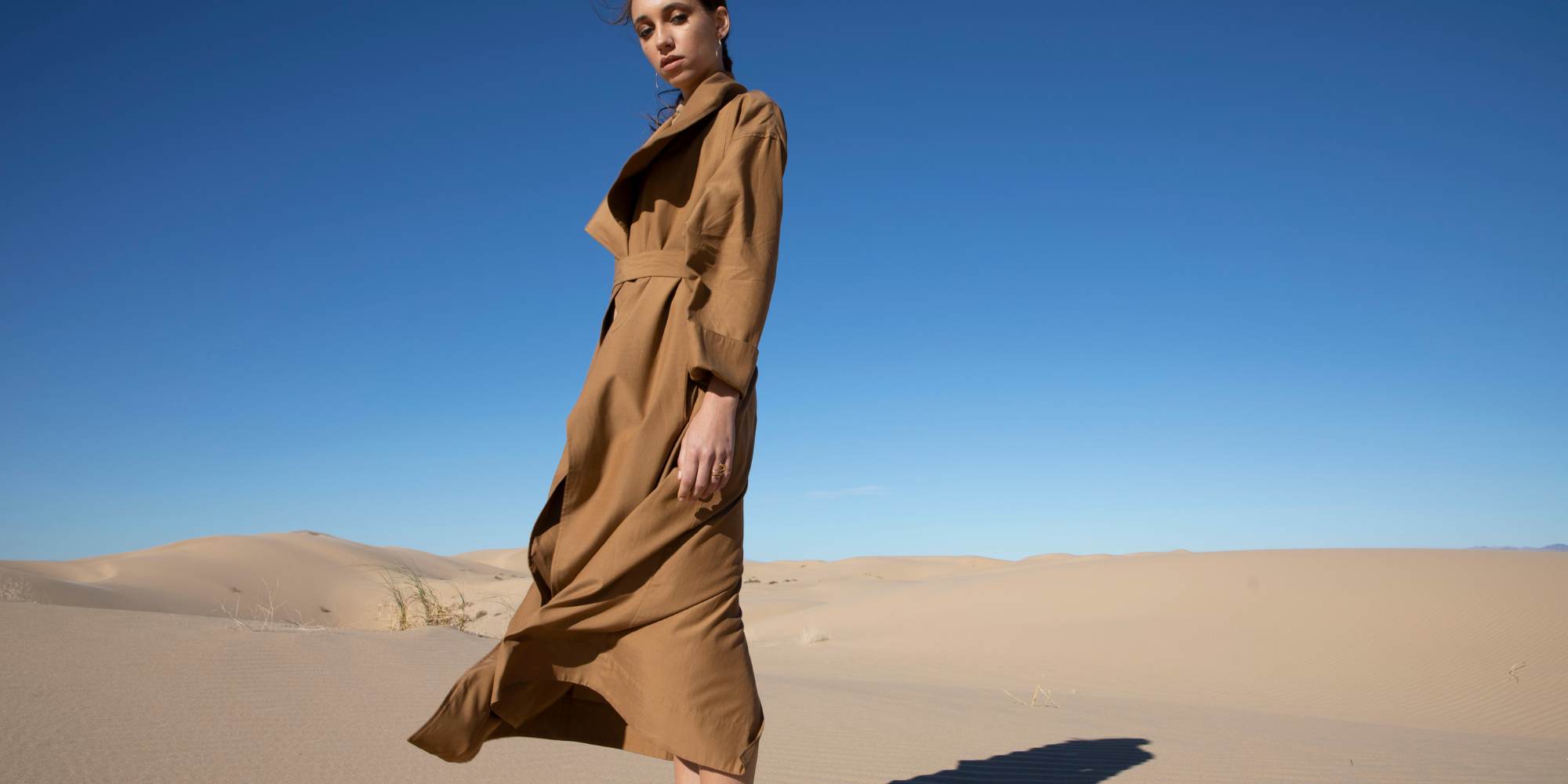 Someone in a dessert landscape wearing clothing by Lacher Prise.