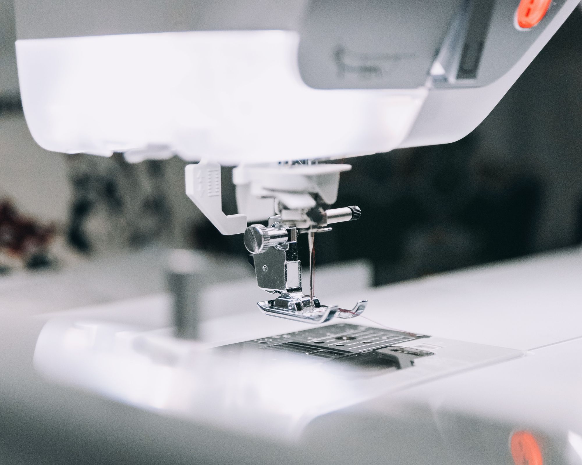 Close up of a sewing machine needle in black and white.