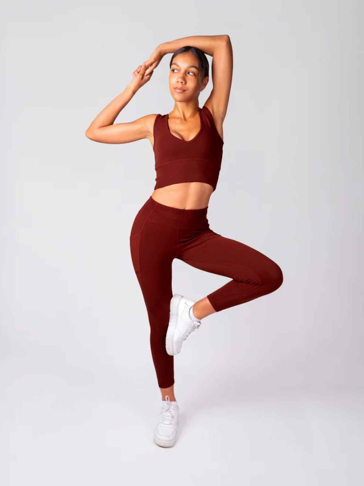person doing stretch wearing more sustainable activewear from happy earth