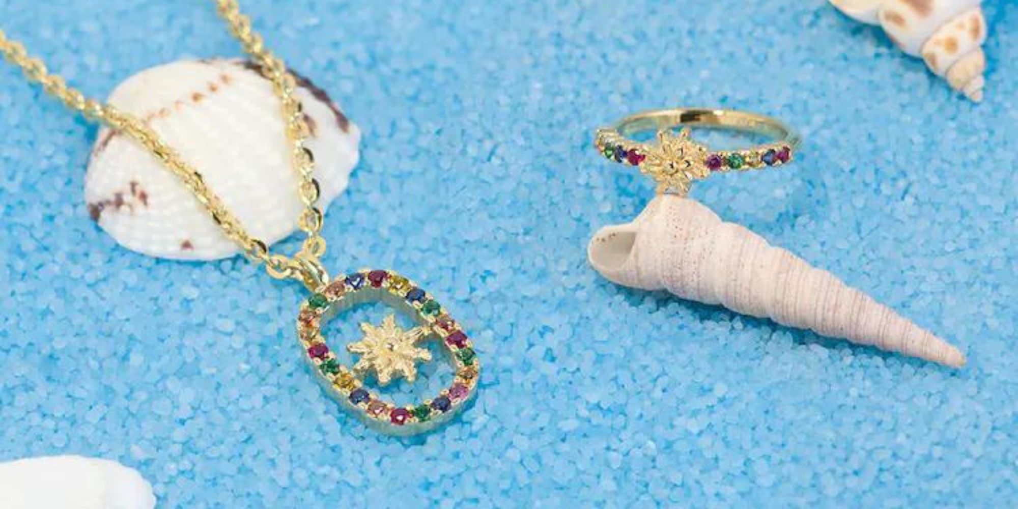 Close up of responsibly-made jewellery by Eguzkilore laying across shells.