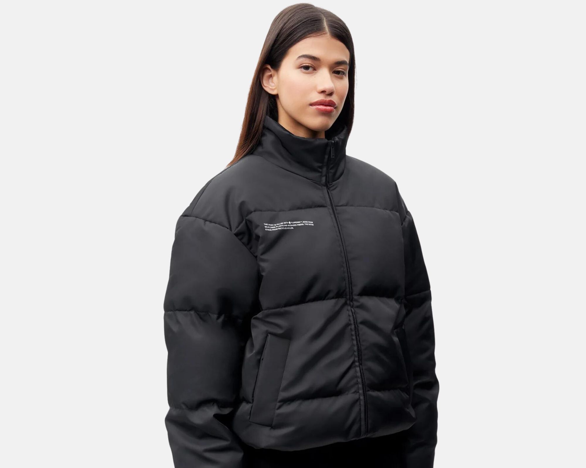A black puffer jacket made with vegan plastic-free material flower down FLWRDWN as insulation by PANGAIA.