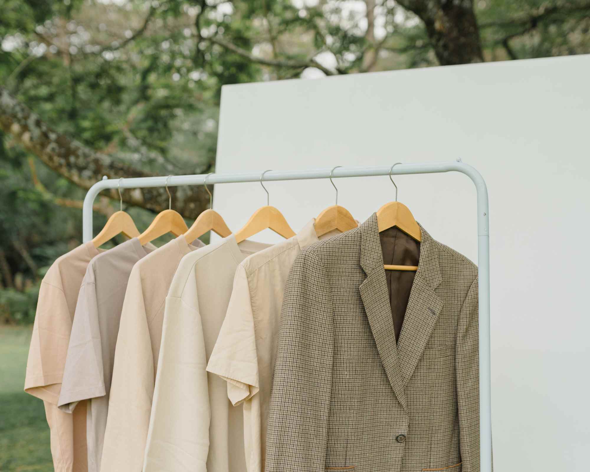 clothing rack featuring beige items and checked blazer