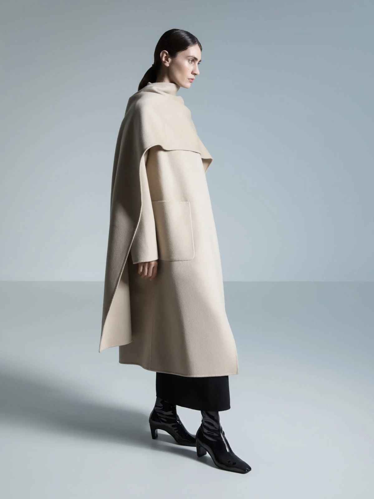 person wearing beige coat and black shoes from essen