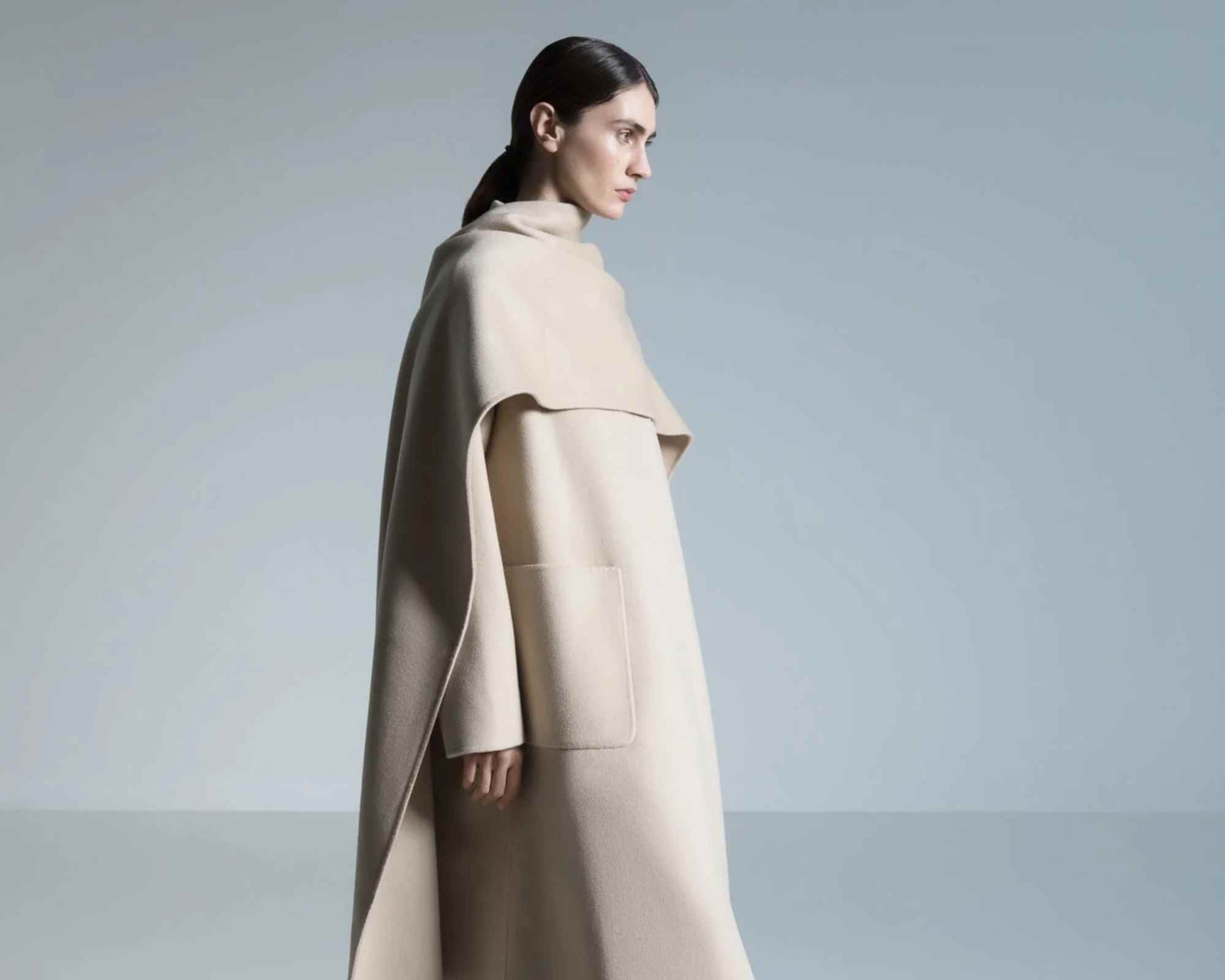 person wearing beige coat and black shoes from essen