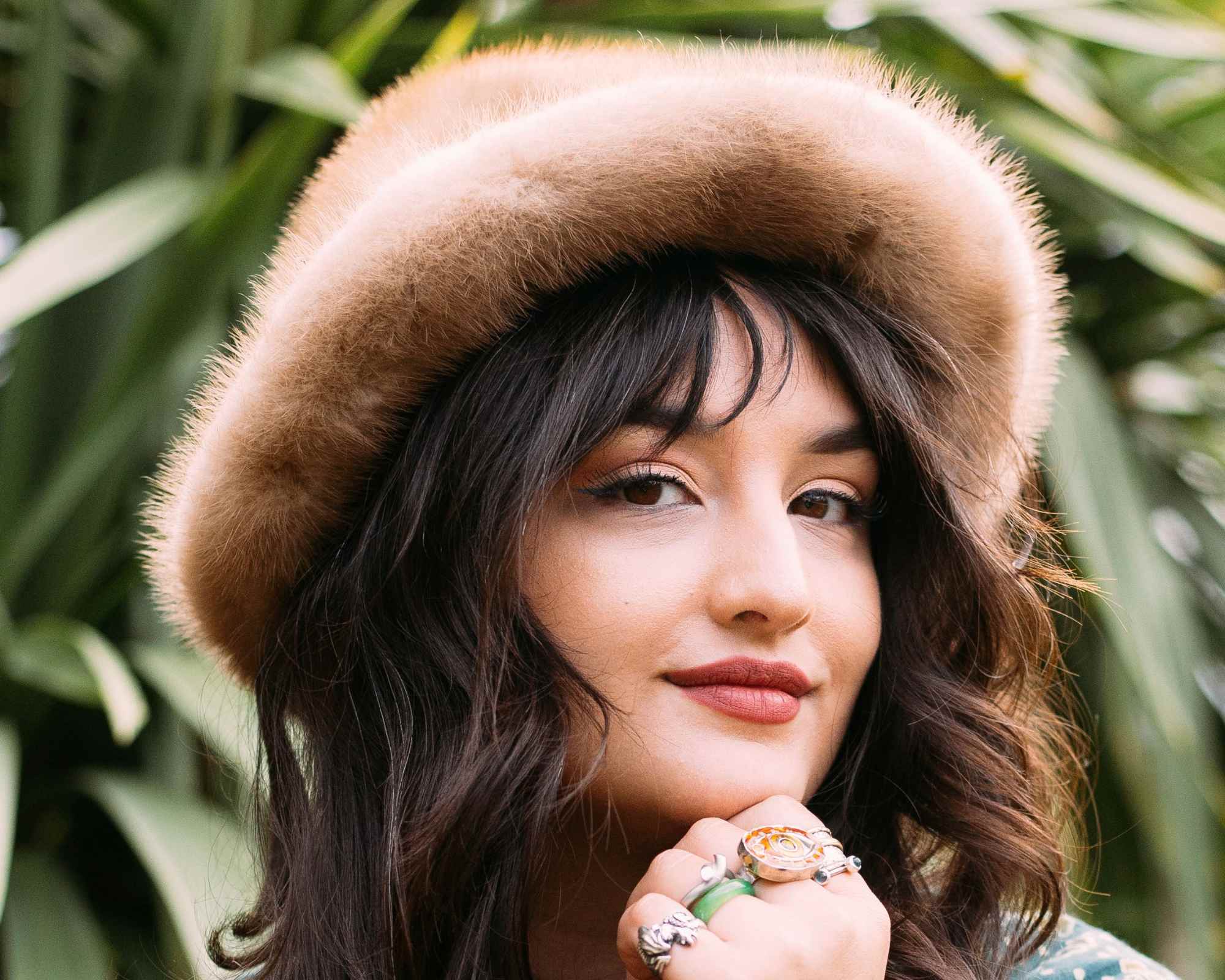 Portrait of Fashion Revolution's Liv Simpliciano wearing fluffy hat