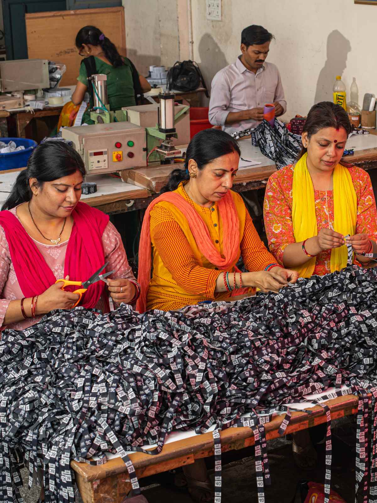 Garment workers cutting labels