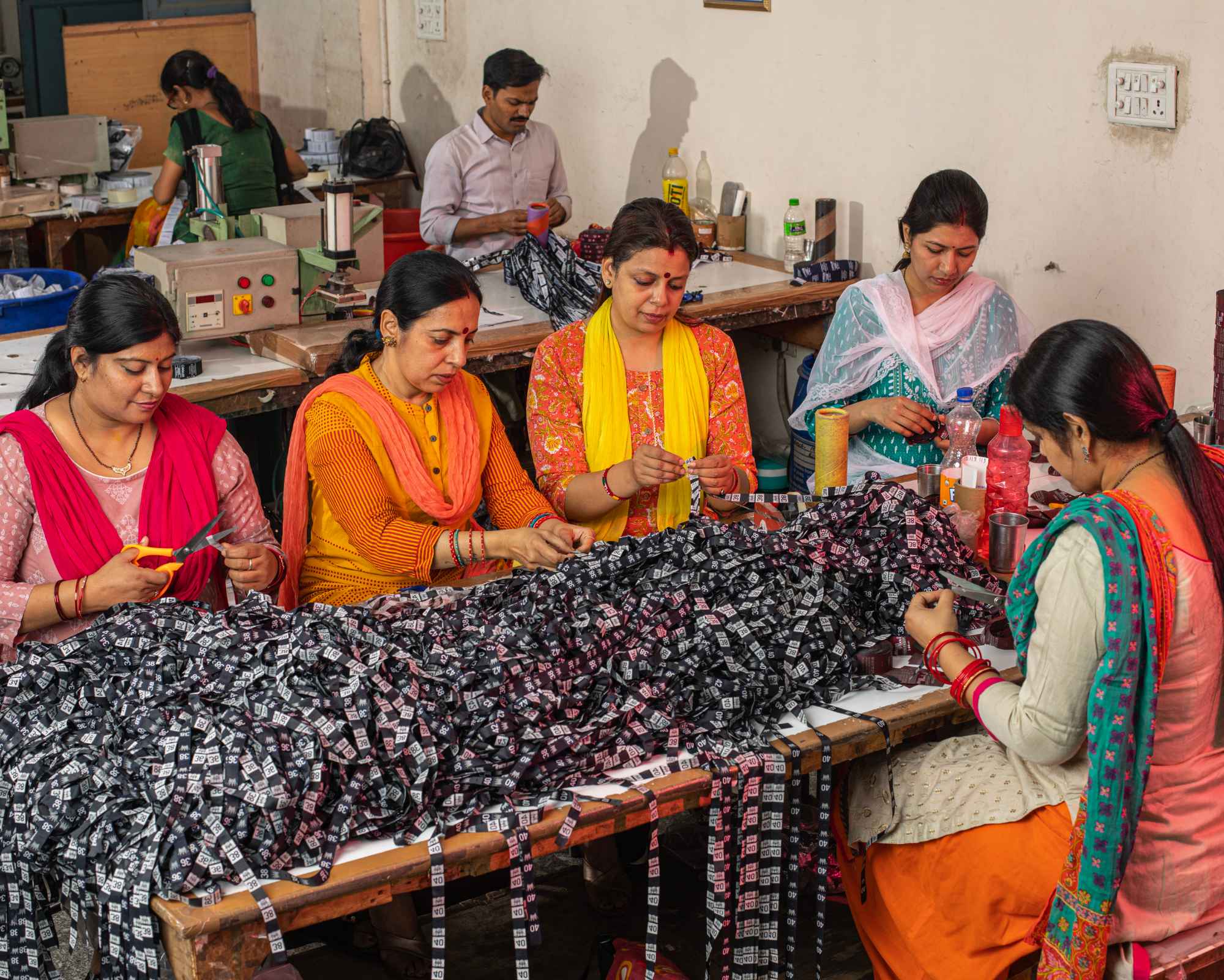 Garment workers cutting labels