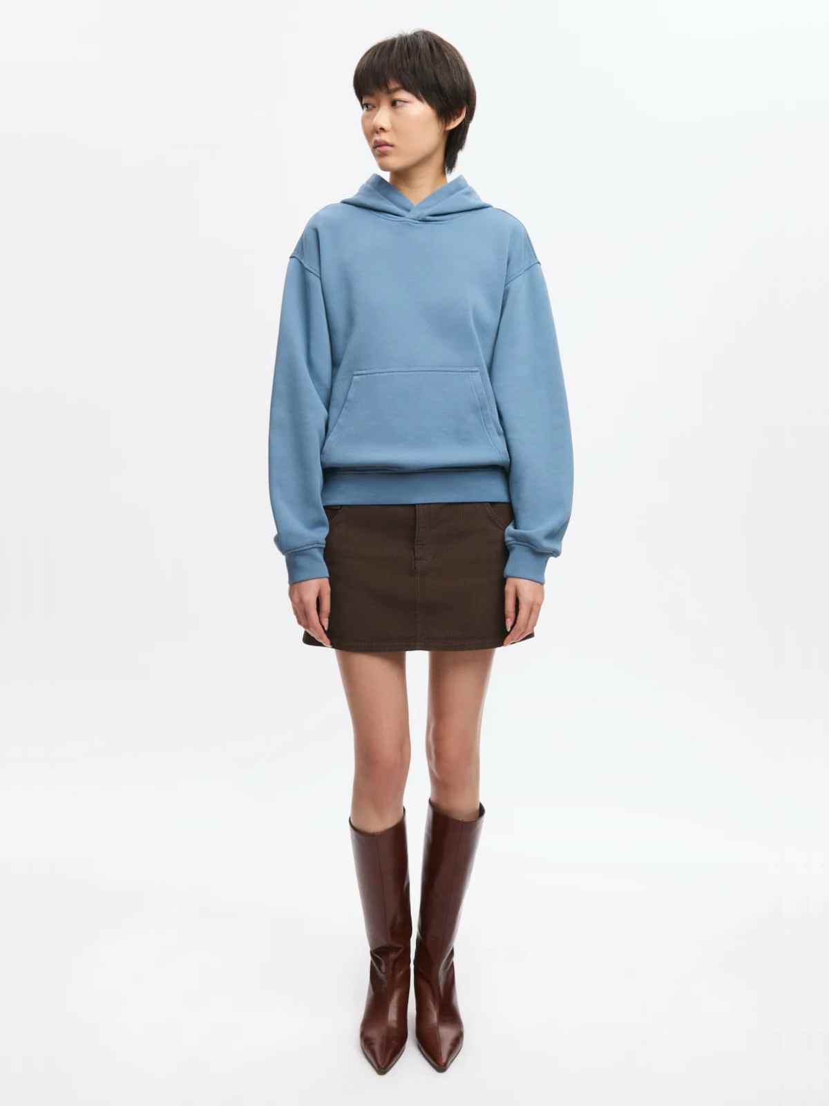 person wearing more sustainable hoodie underr $100 from kotn