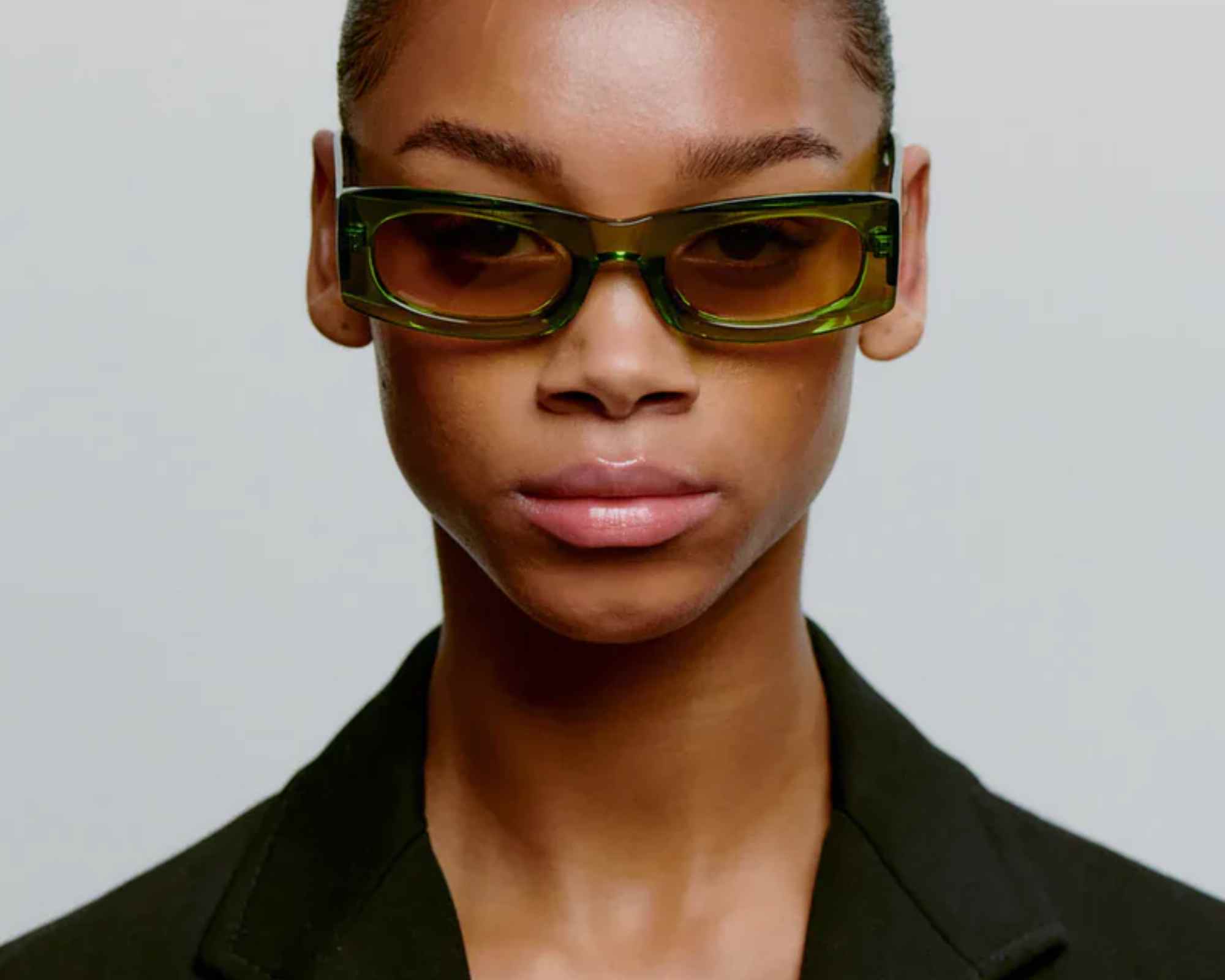 person wearing green more sustainable sunglasses from komodo